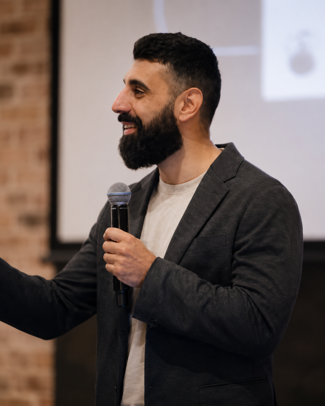 Moussa Namini speaking on stage