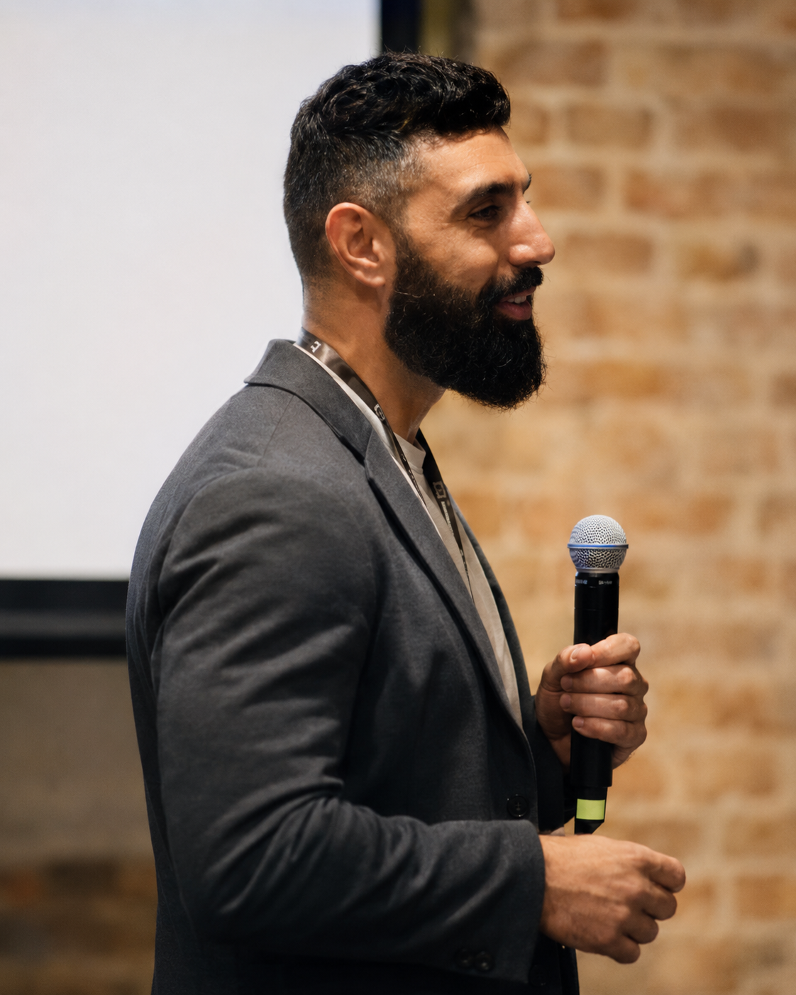 Moussa Namini speaking on stage